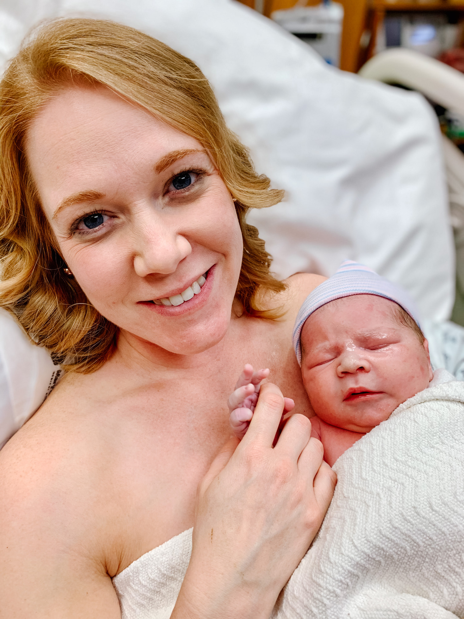new mom holding newborn in hospital 2020 pandemic