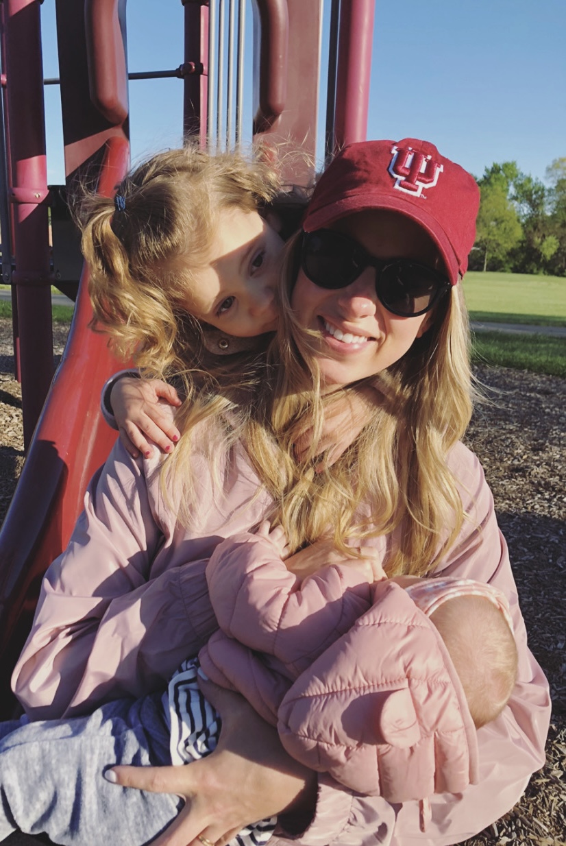 Mom and two daughters playing at a park